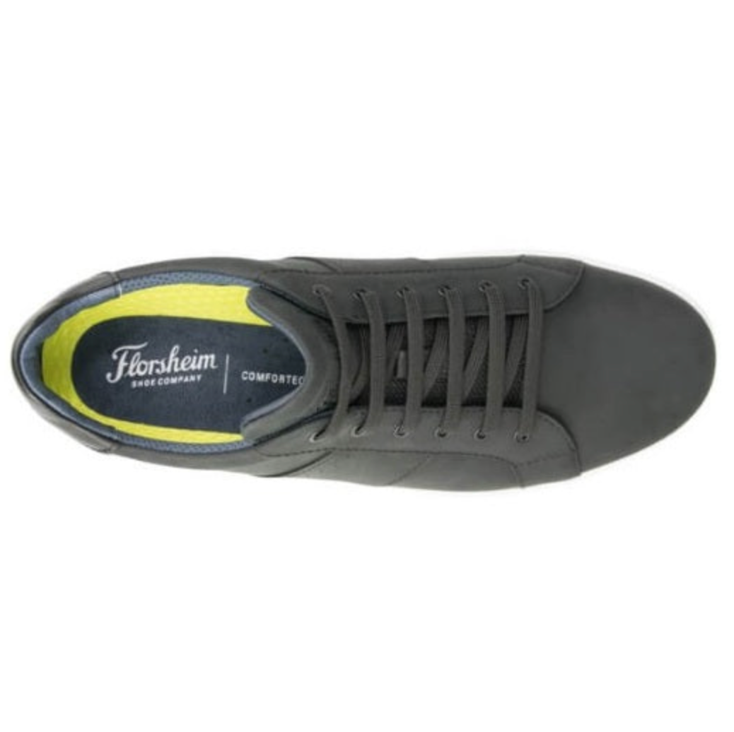 Top view of a dark gray Florsheim Crossover Lace Sneaker with a bright yellow interior lining, featuring a slip-resistant insole branded "Florsheim Shoe Company Comfortech" and a cushioned footbed. This lace-up leather sneaker showcases a sleek, minimalist design.