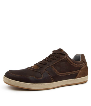 The Colorado Eiko Leather Sneaker is a brown casual shoe with dark brown accents, a light beige sole, and an oiled leather upper. It features stitching details, a textured side panel, and a lace-up design with a rubber grip outsole for better traction.