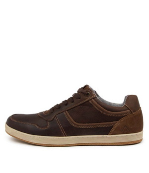 The Colorado Eiko Leather Sneaker is a brown leather shoe with an oiled upper, dark brown laces, and beige rubber sole. It has a smooth toe cap, textured heel detail, panel stitching, and a striped interior lining for added flair.