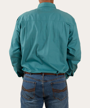A person wearing a teal Ringers Western King River Half Button Shirt and blue jeans is shown from the back. The 100% cotton shirt is untucked, complementing the jeans with visible stitching on the back pockets. The background is plain white.