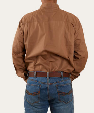 A person wearing a brown Ringers Western King River Half Button Shirt and blue jeans, viewed from the back. The individual has their hands in their pockets, and a brown belt is visible around the jeans.