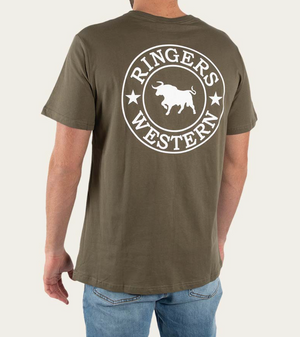 A person wears a green Ringers Western Signature Bull Classic T-Shirt, made of 100% cotton, with a white bull and stars logo on the back. Paired with blue jeans, they're shown from behind, capturing the casual yet iconic look.