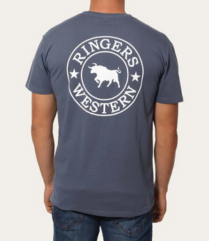 A person sports the Ringers Western Signature Bull Classic T-Shirt in gray, featuring "Ringers Western" and a white bull graphic on the back. Crafted from pre-shrunk cotton, it effortlessly complements their blue jeans, highlighting a laid-back style from behind.