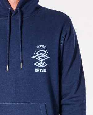 Person wearing a Rip Curl Search Icon Hood in navy blue, crafted from organic brushed cotton, displaying a white geometric design and "Rip Curl" on the chest. The hoodie has a drawstring and cozy fleece lining, pictured from neckline to waist.