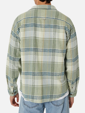 Dressed in an Industrie The Anderson Shirt, a green and beige checkered flannel crafted from comfy cotton, the person pairs it perfectly with light blue jeans. They're facing away from the camera.