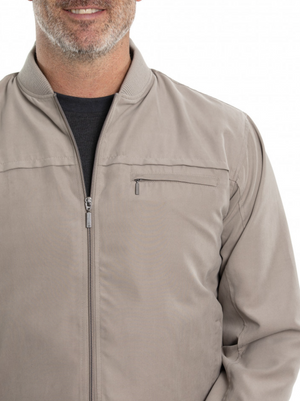 A man in a cozy Breakaway Microfibre Bomber Jacket, featuring a gray zip-up design with a high collar and zippered pockets, is layered over a black shirt. Only the lower half of his bearded face is visible in the image.