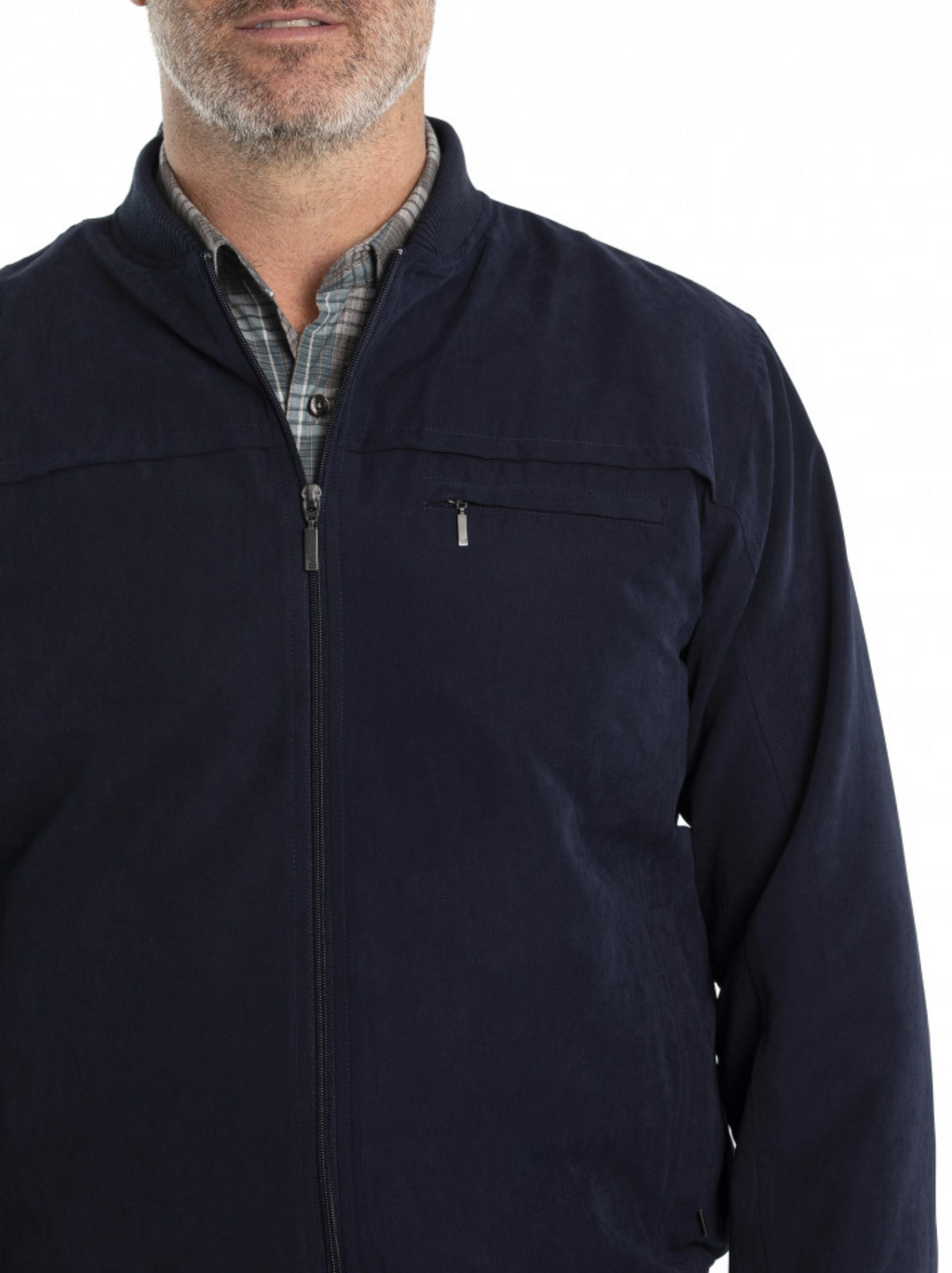 A man in a dark navy Breakaway Microfibre Bomber Jacket with a rib knit collar and full zip front wears it over a gray plaid shirt. The jacket has a visible zippered chest pocket, capturing the bottom half of his face.