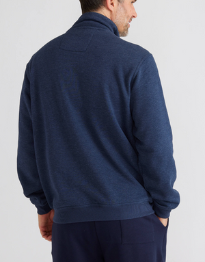 A man embodies effortless style and charm, standing with his back to the camera in a Breakaway Bello Snowy Mt Fleece Jacket paired with dark pants against a plain white background.