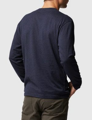 A person is shown from the back against a plain background, wearing a sports fit dark blue Rodd & Gunn Long Sleeve Gunn T-Shirt and dark green pants, both made from 100% Cotton.