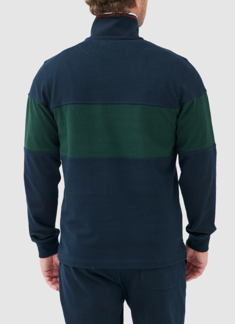 The person is wearing the Rodd & Gunn Foresters Peak Sweat, a navy and dark green sweatshirt made from 100% cotton mid-weight jersey. It features a horizontal green stripe on the back and a funnel neck. They are facing away with arms relaxed by their sides.