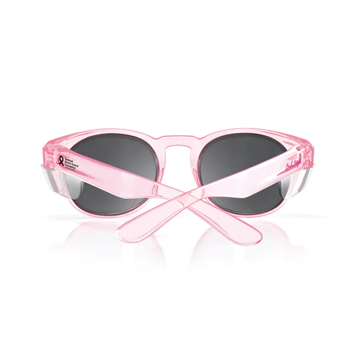 The SafeStyle Cruisers feature a pink frame and polarized dark lenses with crossed arms showing a ribbon logo and text near the hinges. These chic sunglasses provide UV400 protection, ensuring your eyes are shielded from harmful rays while maintaining style.