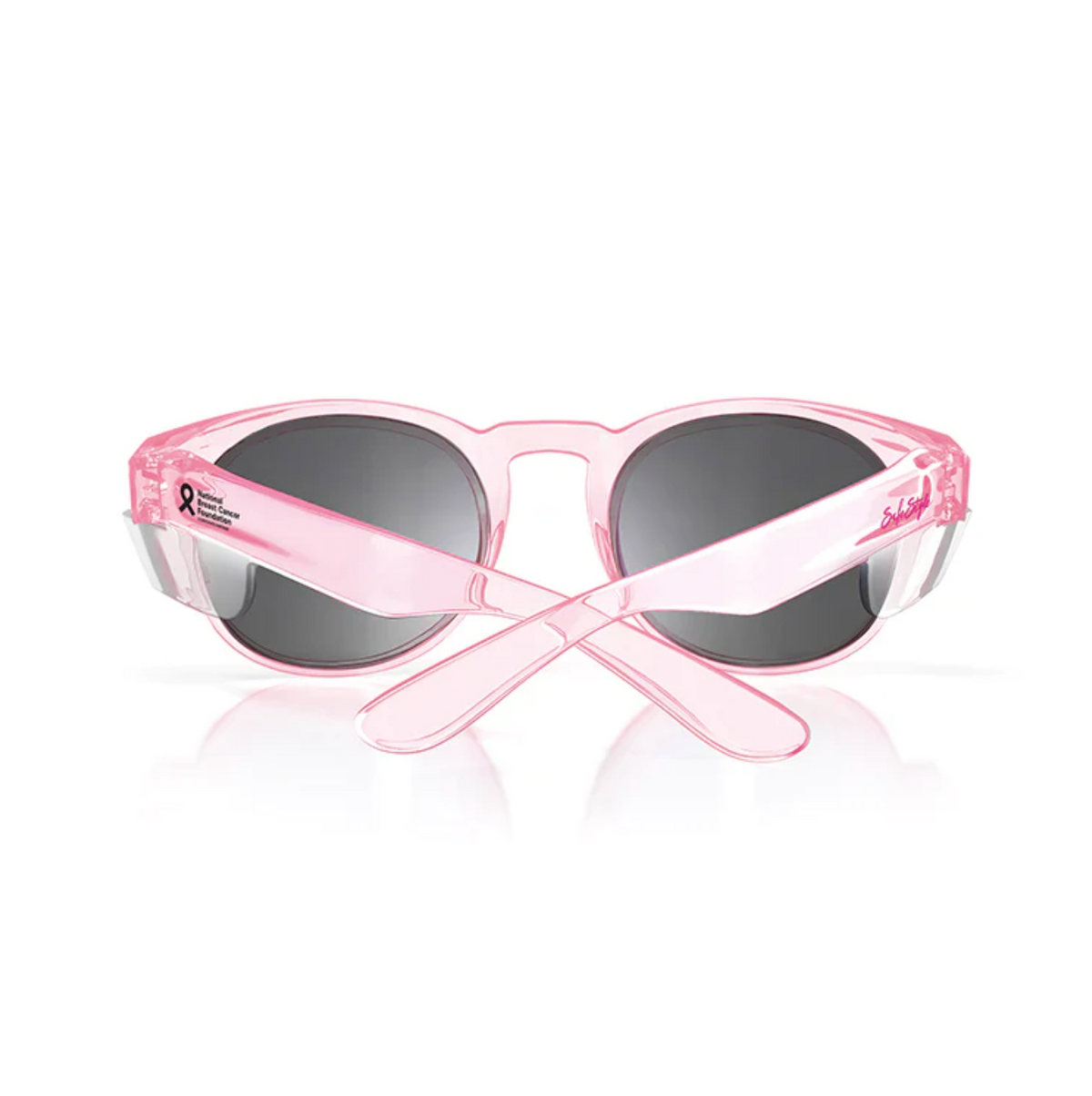 The SafeStyle Cruisers Pink Frame Tinted Lens sunglasses feature crossed arms displaying a breast cancer awareness ribbon and text. With polarised, UV-protection black lenses and excellent safety ratings, these stylish shades ensure clear vision and reliable sun protection.