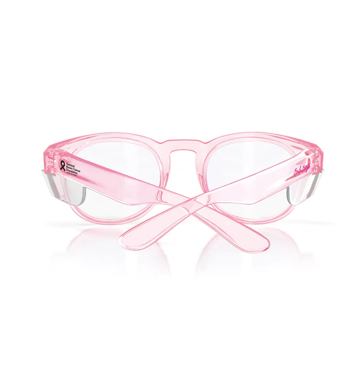 The SafeStyle Cruisers offer transparent pink frames with clear lenses, featuring a breast cancer awareness ribbon and logo on the temples. They provide UV protection and have uniquely styled crossed earpieces to shield your eyes while making a statement.