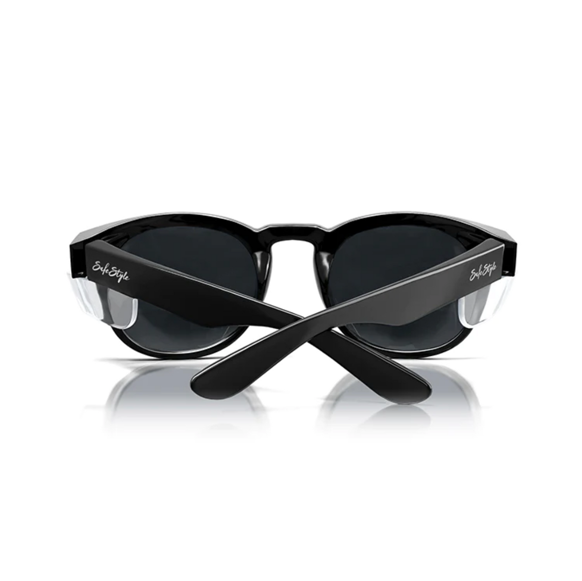 The SafeStyle Cruisers feature a chic wraparound design, glossy black frame, and polarized lenses for superb UV protection. "Solo Style" adorns the arms as they rest upright on a reflective surface.