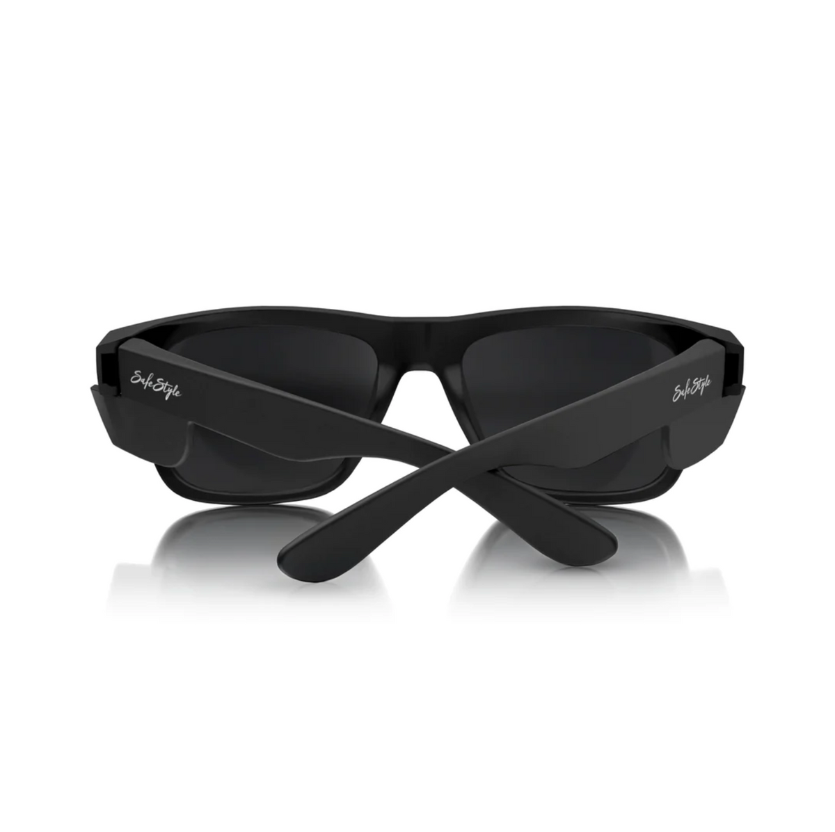Matte black SafeStyle Fusions sunglasses with crossed arms and reflective rectangular lenses, featuring UV protection. "SafeStyle" is written in white on the temples. Displayed against a plain white background.