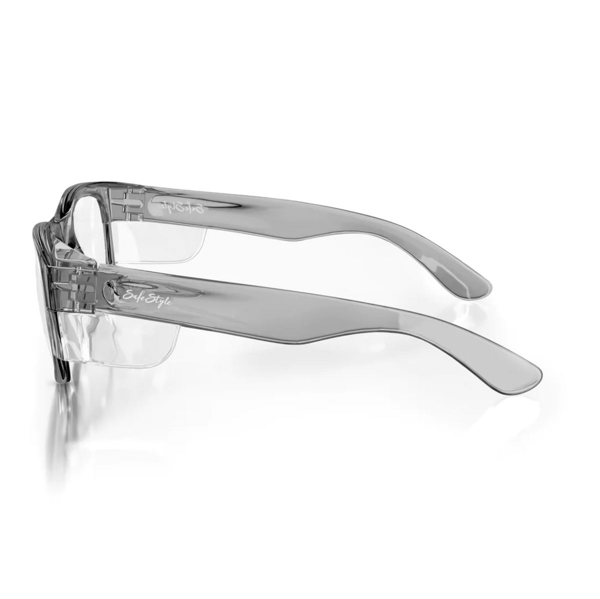 The SafeStyle Classics Graphite Frame Clear Lens glasses have a sleek design with wide temples, lightweight polycarbonate frames, clear UV-protective lenses, and a subtle side logo, making them ideal as protective eyewear.