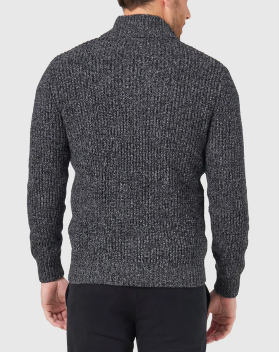 Facing away, a person wears the Blazer Oscar Button Neck Knit in dark gray with black pants against a plain white background.