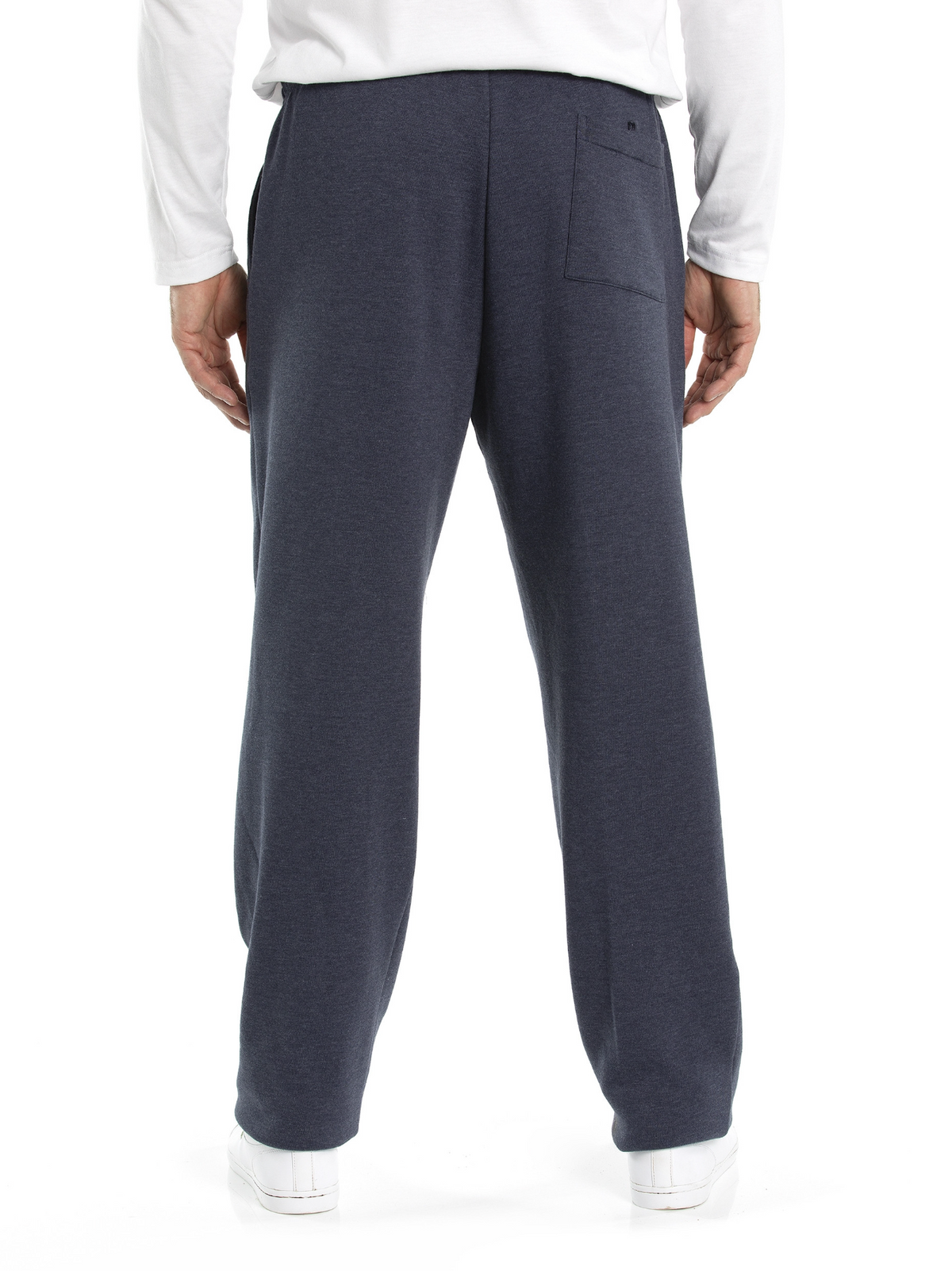The image shows the back view of a person wearing Breakaway Snowy Mt Fleece Pants in dark blue and a white long-sleeve shirt. The pants feature a small pocket on the back right side. Ready for some casual weekend wear, the person is standing against a white background and sporting white sneakers.