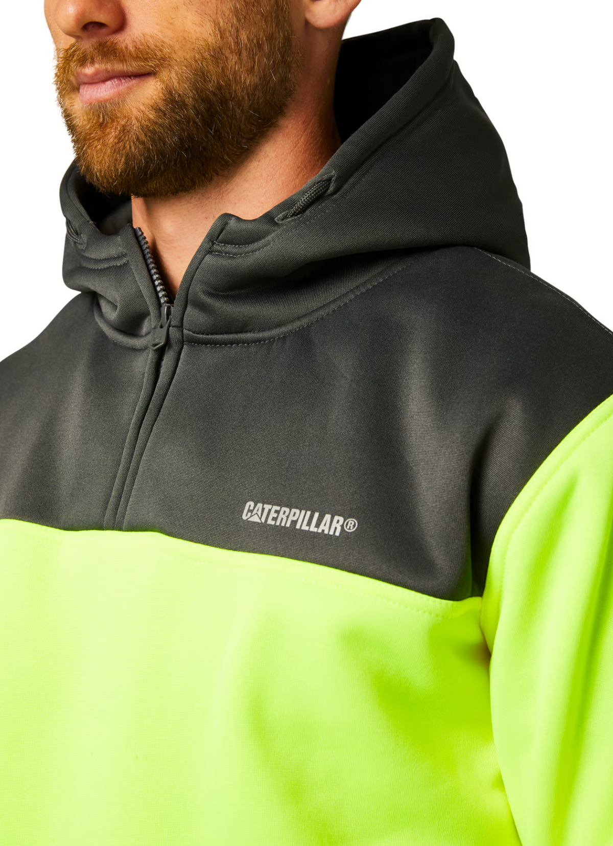 Close-up of an individual sporting the CAT Hi Vis Hoodie, showcasing its rugged dependability and prominent Caterpillar logo on the chest. The hoodie boasts a vibrant yellow and black color scheme, complemented by a front zipper and soft fleece lining. The person, who has a short beard and is turned slightly to the side, is set against a white background.