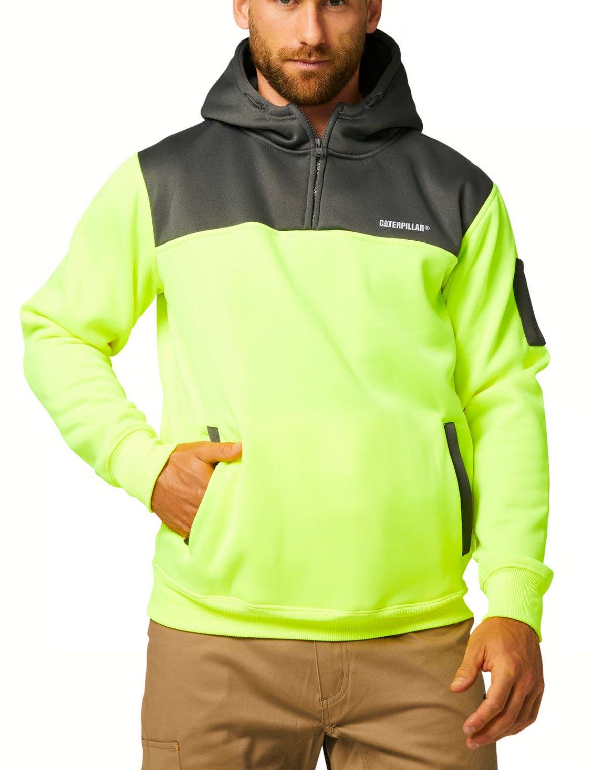 A man is wearing a neon yellow and gray hooded CAT Hi Vis Hoodie with a front zipper and "Caterpillar" logo. This ruggedly dependable sweatshirt includes a front pocket, an additional pocket on the left sleeve, and fleece lining. He is also dressed in light brown pants.