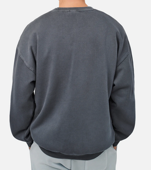A person is seen from the back wearing an oversized Industrie The Del Sur Sweat, which has long sleeves and a crew neck, set against a plain white background.