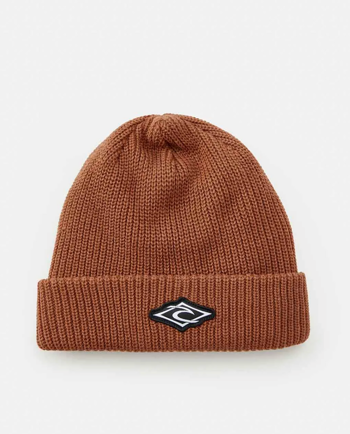 The Rip Curl Icons Reg Beanie is a brown knit beanie with a fleece lining, folded brim, and features a small black and white geometric logo patch on the front, set against a plain white background.