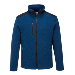 The Portwest KX3 Performance Fleece is a blue and black zip-up jacket with a high collar. This comfortable jacket features three zippered pockets—one on the left chest and two at the waist. Reinforced panels add durability, while black accents adorn the shoulders and zippers. The fabric has a textured appearance.