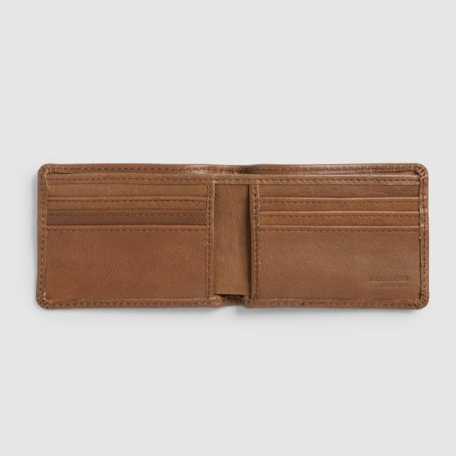 The Rodd & Gunn Victoria Flats Road Wallet, made from buffalo leather in open brown, offers multiple inviting card slots. Its minimalist design stands out against a plain gray background, highlighting its rugged elegance and ready-for-anything charm.