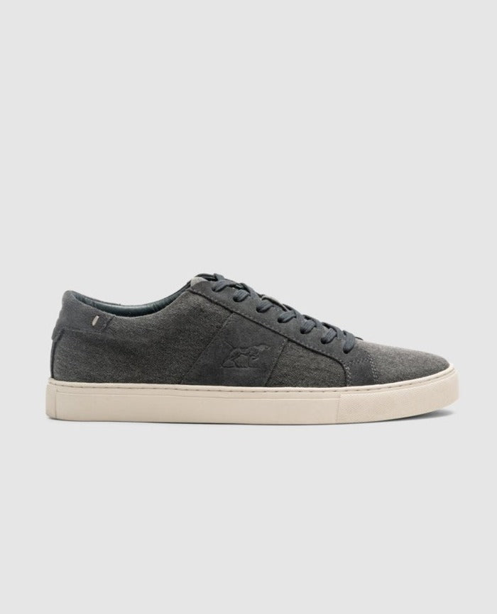 The Rodd & Gunn Endeavour Sail Sneaker is a gray casual shoe with a white rubber sole and suede leather trims. It boasts a low-cut design, gray laces, an embossed logo on the side, and a moulded footbed for added comfort.