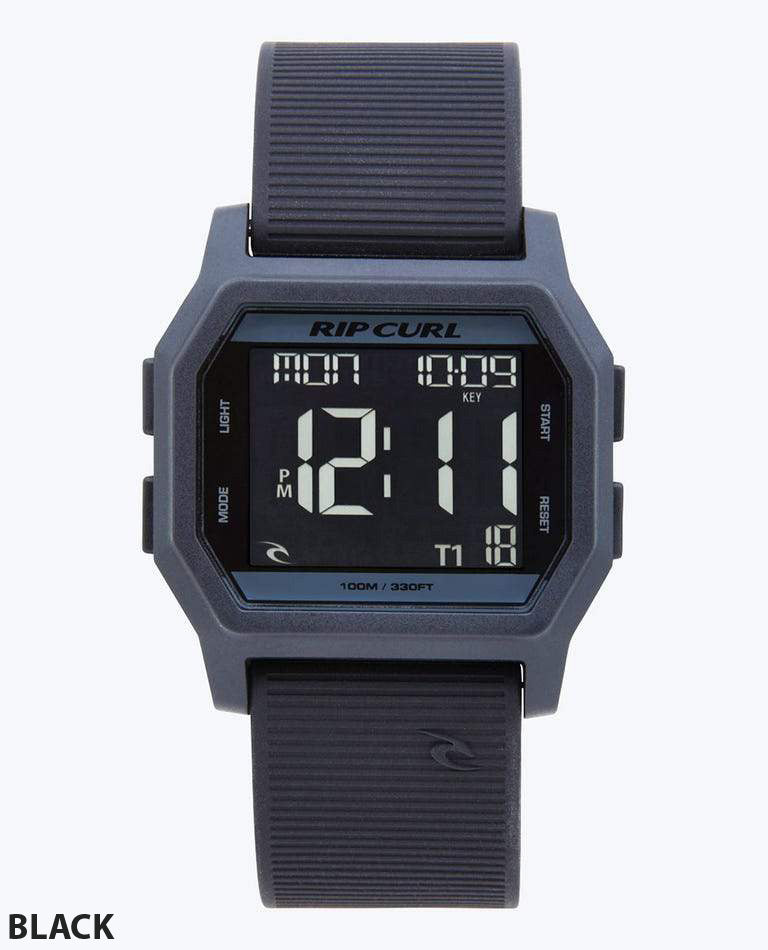 The Rip Curl Atom Digital Watch features a waterproof rectangular black case, black ribbed band, and digital display showing time, date, and more. "BLACK" appears in the lower left corner.