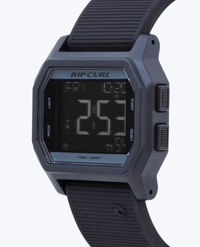 The Rip Curl Atom Digital Watch features a square black face, textured black band, and side buttons. It displays the time (2:57 PM), date, and multiple functions, with a waterproof design for durability.