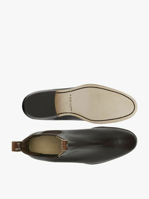 Top and bottom views of the dark brown RM Williams Adelaide Kangaroo Boot, featuring a smooth kangaroo leather upper, light tan sole with visible stitching, black heel, and ankle pull tab.