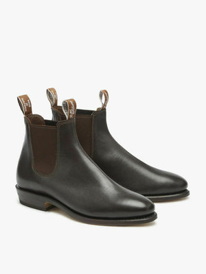 A pair of RM Williams Adelaide Kangaroo Boots in black kangaroo leather with brown elastic side panels, front and back pull tabs, and low stacked heels, displayed side by side on a plain white background.