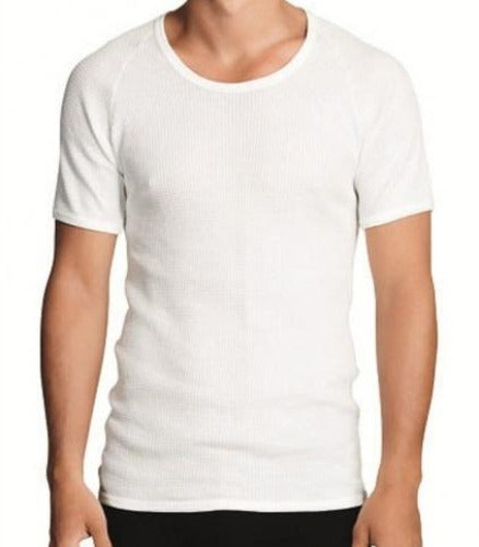 A person wearing a Holeproof Aircel Short Sleeve Tee stands against a plain background. The fitted, white ribbed T-shirt, made from a cotton polyester blend, features short sleeves and a crew neckline. The person is shown from the neck down to the hips.