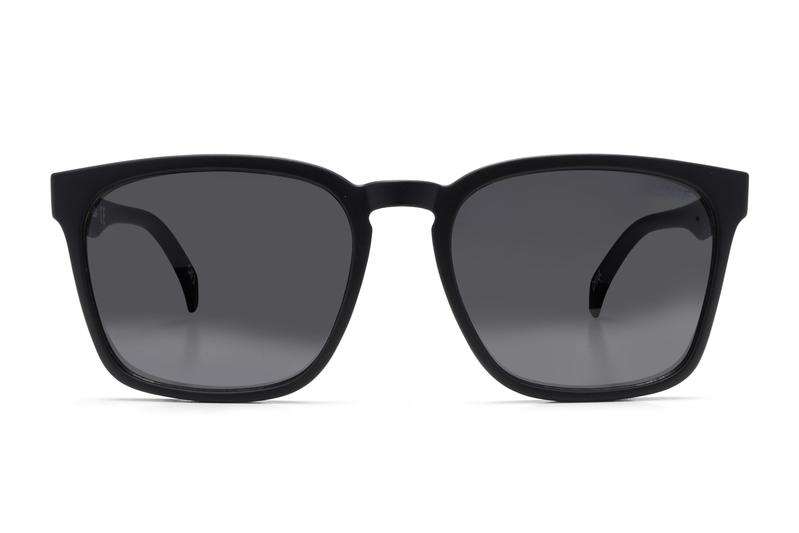 The Liive Alik Sunglasses feature black square frames and dark tinted, optically correct lenses with UV protection, displayed frontally on a white background.