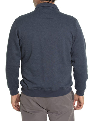 A person wearing the Breakaway Zed Snowy Mt Fleece Half Zip, a dark blue long-sleeve pullover, stands with their back to the camera, illustrating its ideal layering potential. Paired with gray pants, this outfit contrasts elegantly against a plain white background.