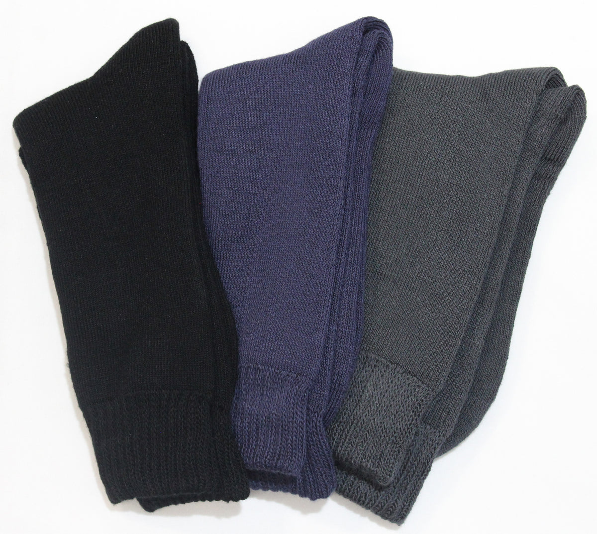 Three pairs of the Bamboo 3 Yarn 3 Pack Work Socks are laid flat next to each other. From left to right, the socks are black, navy blue, and dark gray. Made from an anti-bacterial fabric, these socks have a simple knit pattern and are folded at the cuffs. The background is a plain white surface.