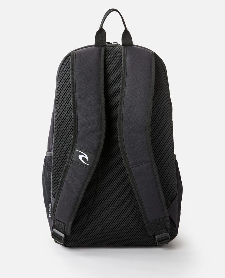 The Rip Curl Ozone 30L School Eco Backpack boasts a sleek black design with padded shoulder straps, a top handle, mesh padding, side pockets, and a laptop compartment. Made from recycled plastic, it also features a small logo on one strap for added style.