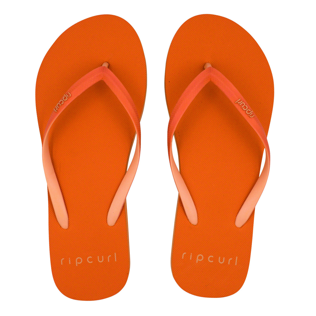 A pair of bright orange Rip Curl Bondi 2 Tone Thongs with matching orange straps laid side by side. The brand name "Rip Curl" is printed on the footbed near the heel in white text. Crafted from a durable thermo rubber compound, these flip-flops feature a simple, casual design that's perfect for summer.