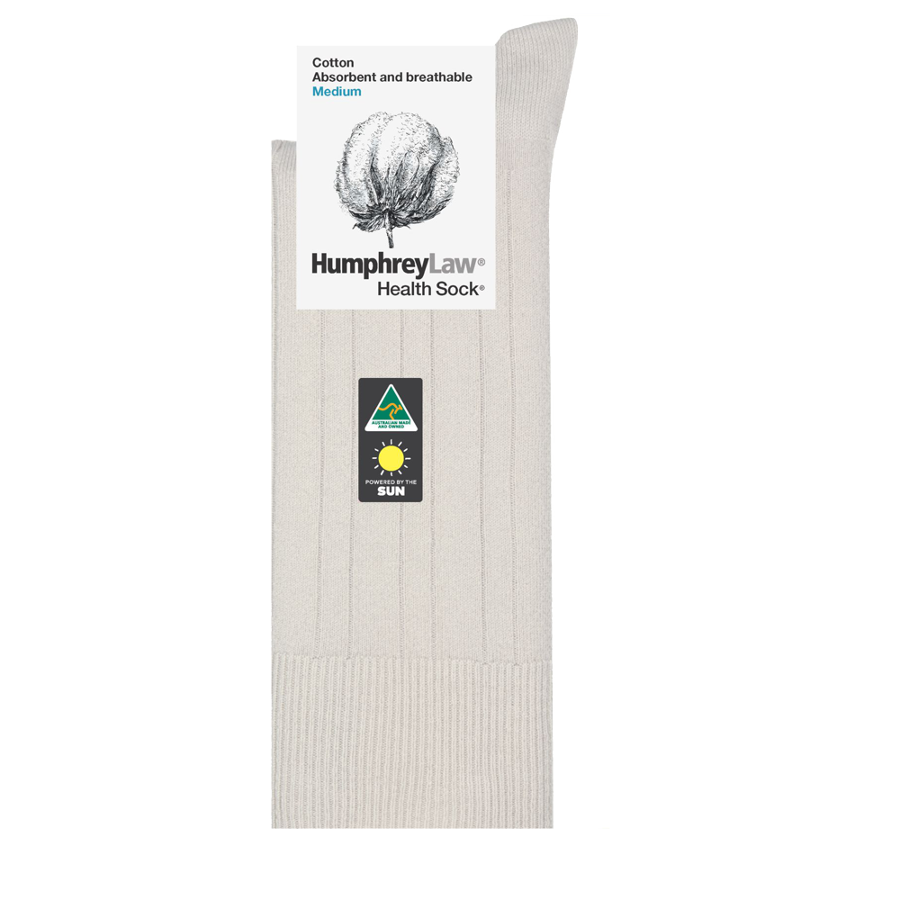 Displayed is a single beige Humphrey Law Pure Cotton Sock, featuring a packaging card with a cotton illustration. The card details the sock's attributes ("lightweight breathable socks," "medium size") and includes a green triangle logo with a stylized sun image.