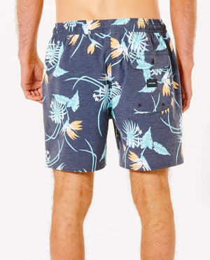 Rear view of a person wearing the Rip Curl Marley Volley Short in navy blue, showcasing a vibrant tropical floral pattern. Made from 100% recycled PET bottles fabric, these comfortable casual shorts feature an elastic waistband and a back pocket with a button closure. The person is standing against a plain white background.