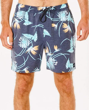 A person is wearing the Rip Curl Marley Volley Short, which features a vibrant floral pattern with light blue, orange, and white tropical flowers set against navy blue. These comfortable, casual shorts are crafted from 100% recycled PET bottles fabric and come with a black drawstring and an elastic waistband. The background is plain white.