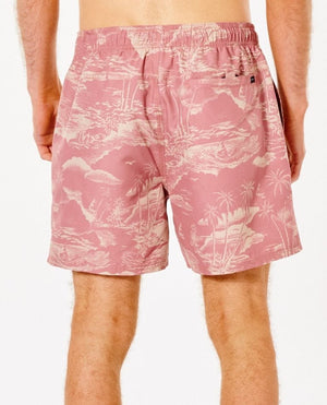 A person wearing Rip Curl Sunset Party Volley, featuring a pink tropical print with islands and palm trees, stands with their back to the camera. The polyester boardshorts have an elastic waistband and a small back pocket against a plain white background.