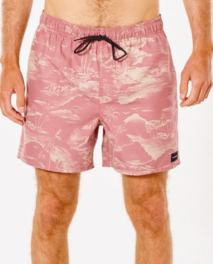 A person wears Rip Curl Sunset Party Volley boardshorts in salmon with a tropical island print of palm trees and waves. Made from polyester, they feature a black drawstring, a small black label on the right side, and a plain white background.