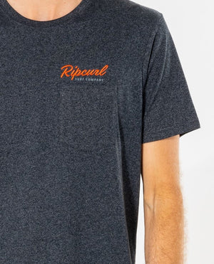 A person in a dark gray Rip Curl Solid Too Easy Embroid Tee featuring "Ripcurl Surf Company" in vibrant orange across the chest. The image highlights the classic crew neck, capturing the upper body from a side angle.