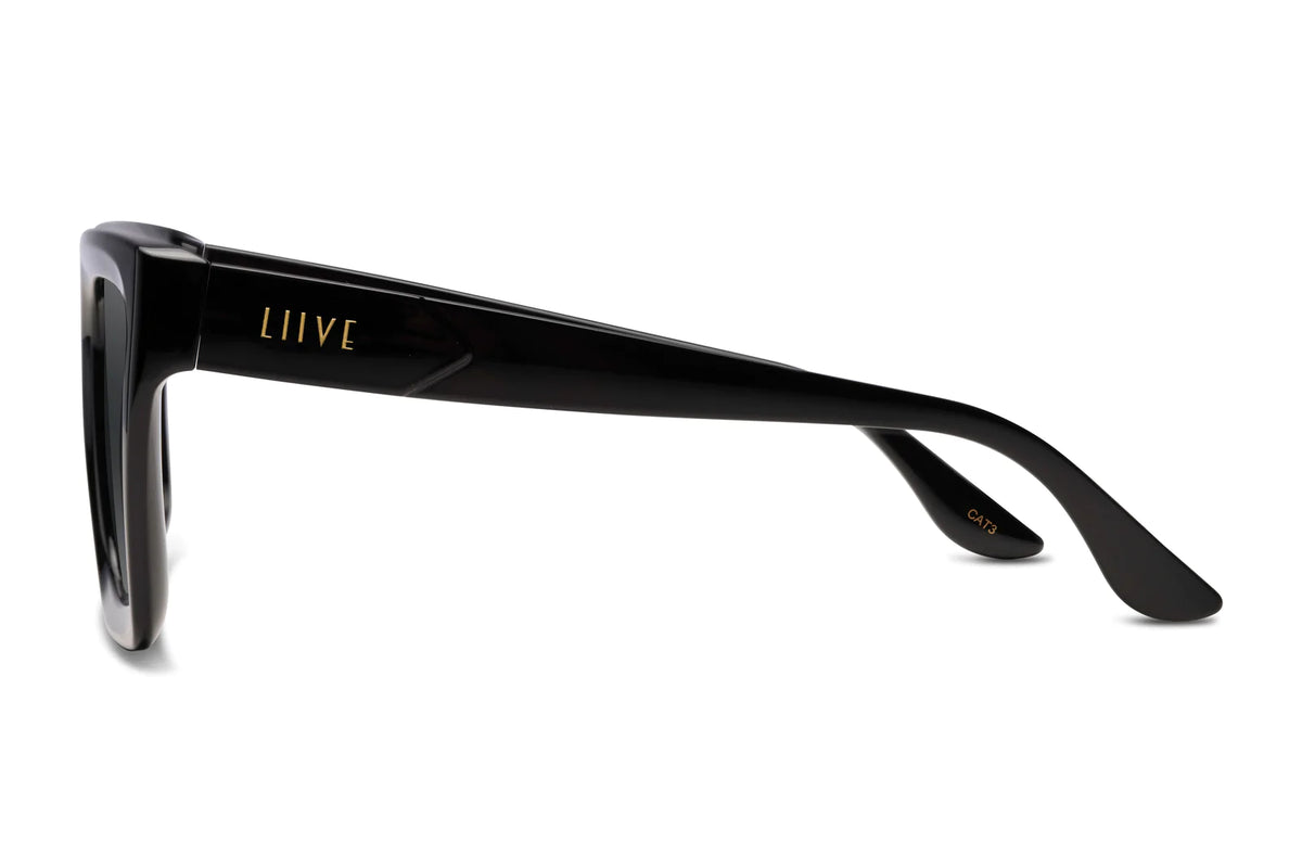 Side view of Liive Desire Sunglasses in black, showcasing "LIIVE" in gold on the temple. Featuring a durable, glossy polycarbonate frame with a rectangular design for both style and UV protection.