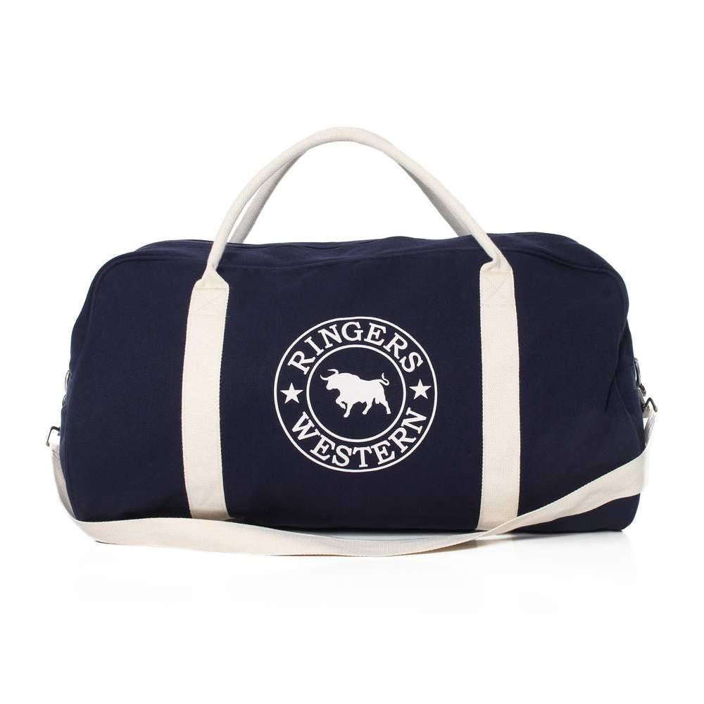 The Ringers Western Gundagai Duffle is a navy blue cotton canvas bag with beige handles and a matching shoulder strap. It showcases a white circular logo in the center featuring a bull and the text "Ringers Western" around it.