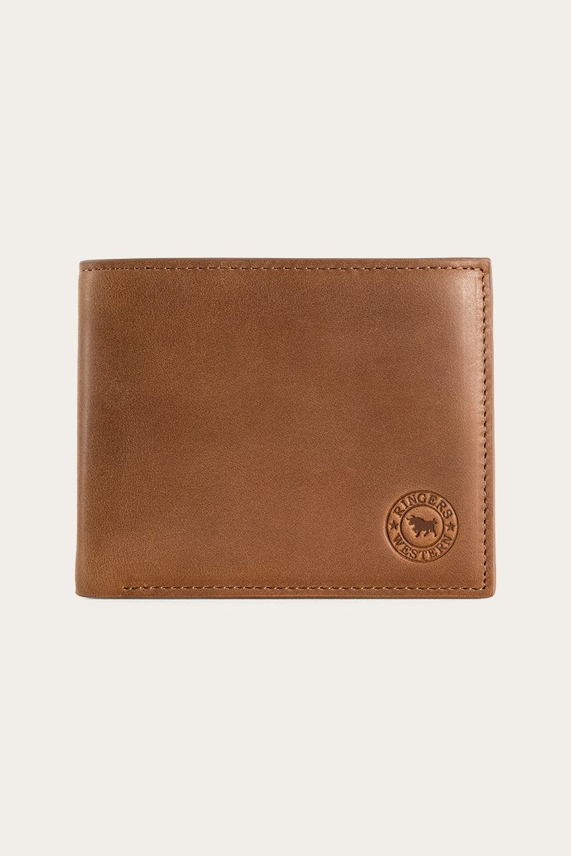 The Ringers Western Duke Wallet, made from genuine leather, showcases a circular embossed logo in the bottom right corner. This brown wallet is elegantly closed and displayed against a light background.