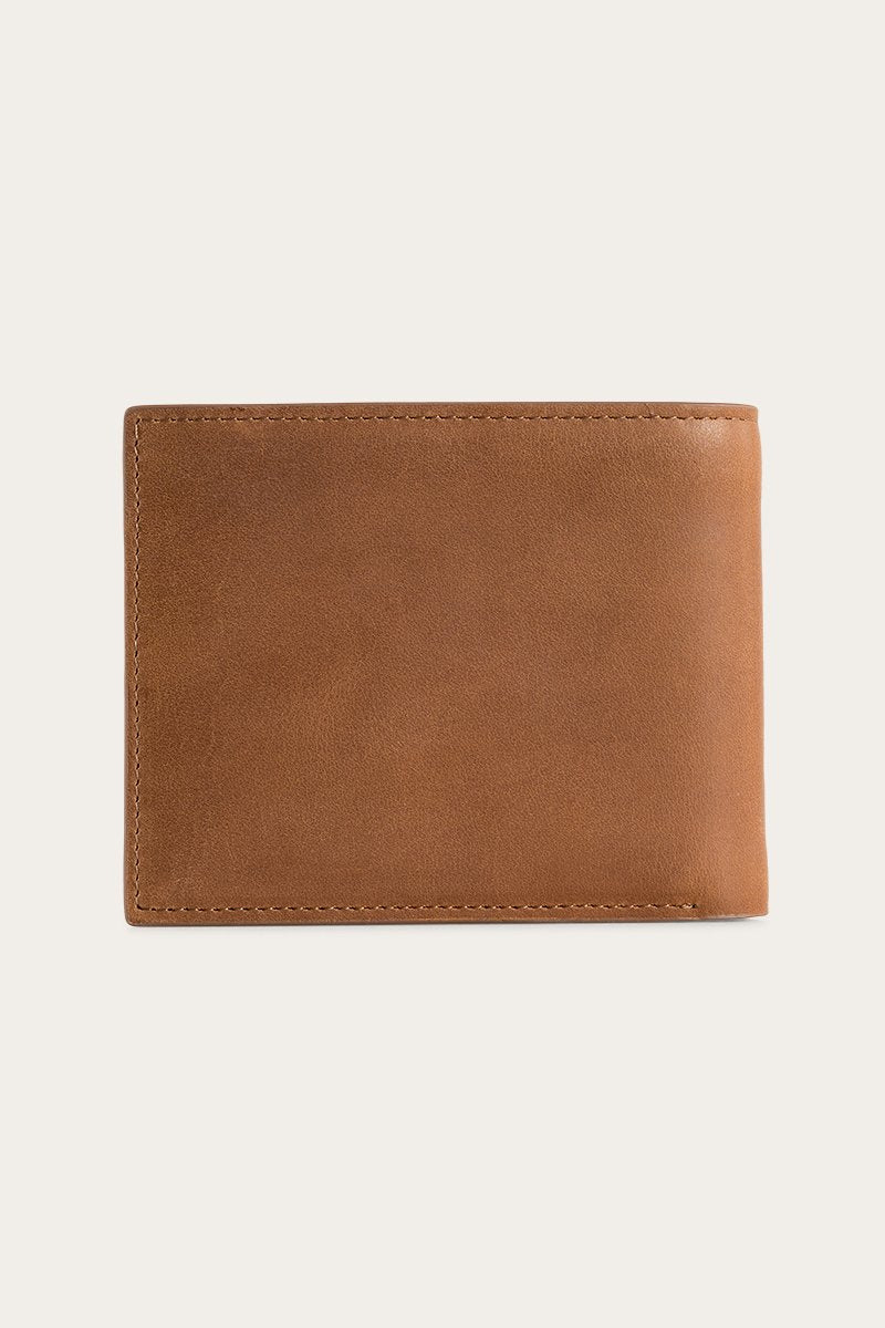 A brown Ringers Western Duke Wallet, made from genuine leather, rests closed against a light gray background. It highlights its smooth texture and minimalist design, appearing new and well-crafted without visible logos or embellishments.