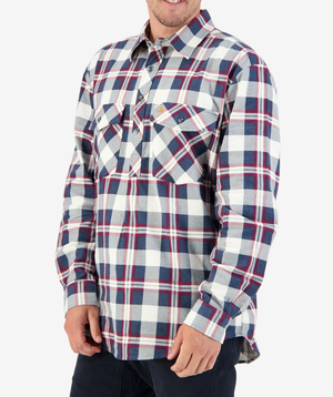 A person smiles with hands at their sides, wearing a red, white, and blue plaid long-sleeve from the Swanndri Egmont Flannelette Twin Pack. The brushed cotton shirt has two chest pockets with buttoned flaps against a plain white background.